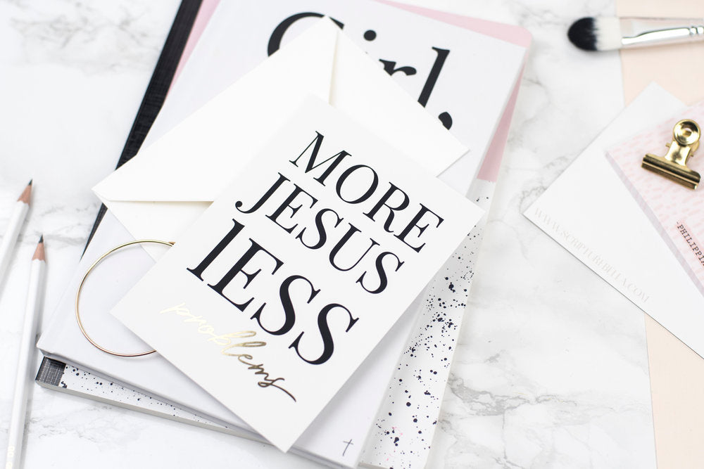 A notecard with the words, more Jesus, less problems