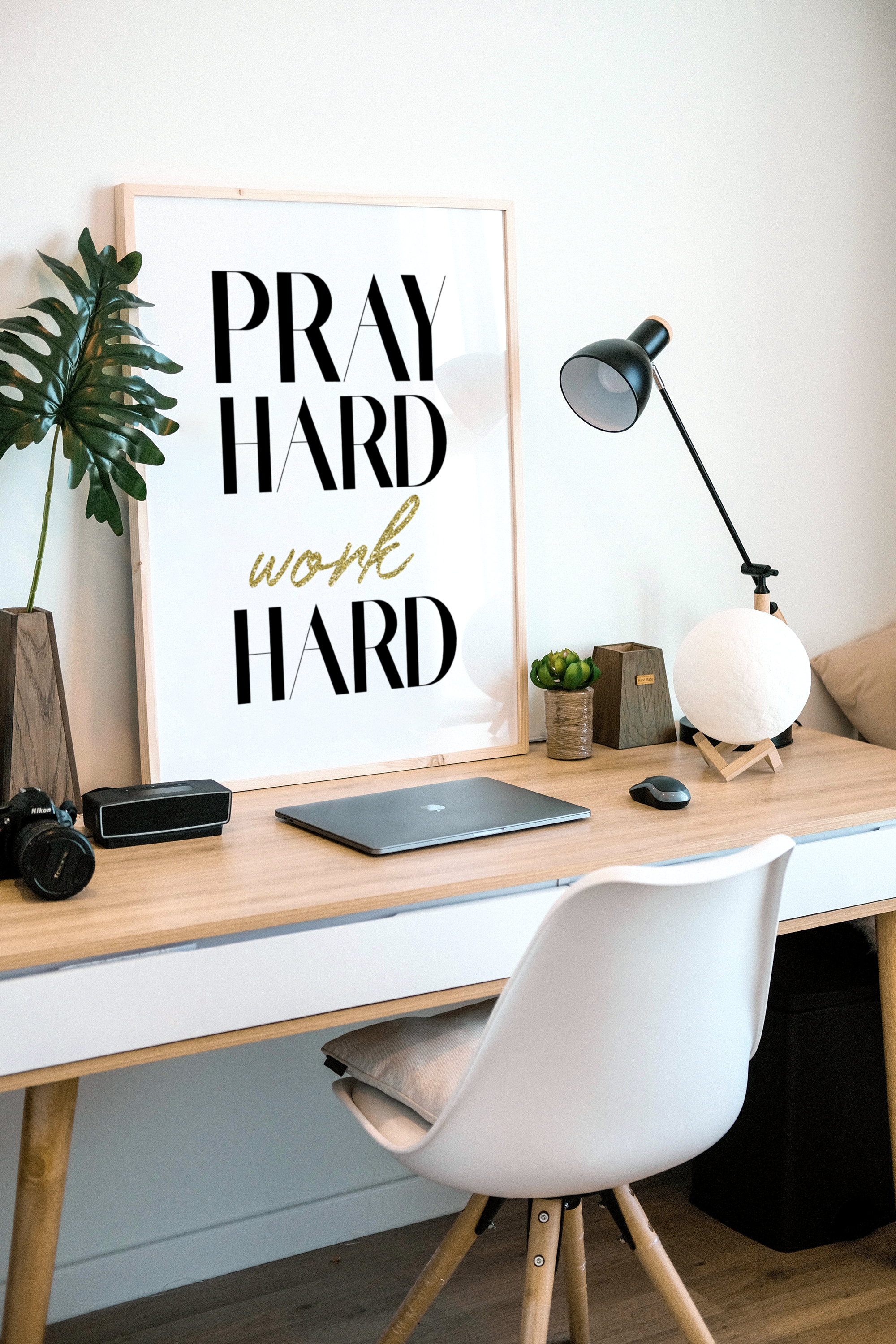 A poster in a frame with the words, pray hard work hard