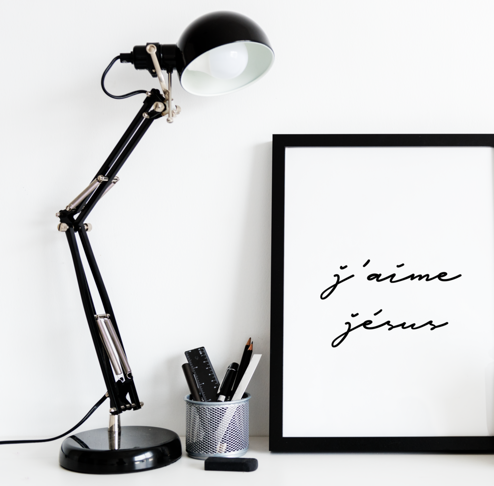 A framed christian wall art with the words J'aime Jesus written in black. 